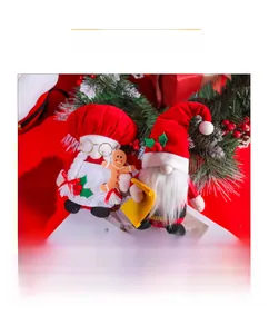 Close-up of red Christmas gnome plush set with chef hat and gingerbread man props