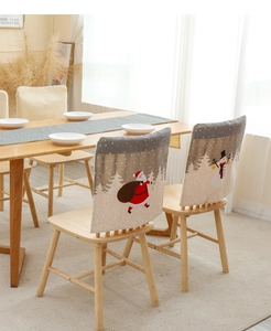 Detailed view of Christmas chair covers with Santa and Snowman motifs on linen fabric