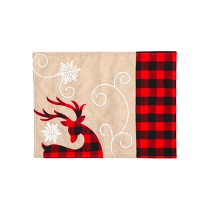 Linen Christmas table mat with reindeer embroidery and red plaid trim on white background