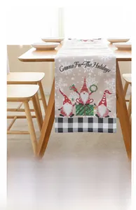 Detail of Christmas gnome table runner with snowflake patterns and black white plaid edges