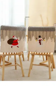 Detail of Christmas chair covers featuring Santa and snowman prints on faux linen fabric