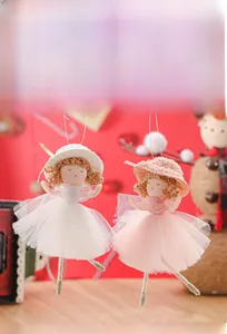 Close-up of handmade Christmas angel dolls with lace skirts and sparkling legs for tree decor