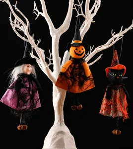 Detail of Halloween hanging ornaments featuring a witch, pumpkin, and black cat with bells