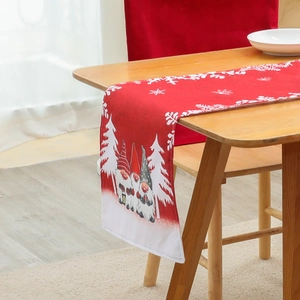 Christmas table runner with red festive gnome design and white snowflakes for holiday decor