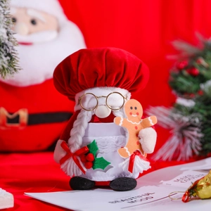 Christmas chef gnome plush doll with red hat holding a gingerbread man ornament