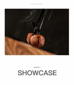 Macro detail of vintage rusty iron bells with black hanging cords for Halloween decor