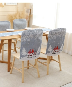 Close-up of blue Christmas chair covers with festive gnome patterns and white snowflakes