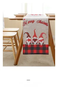 Detail of linen Christmas table runner featuring red plaid trim and gnome motifs