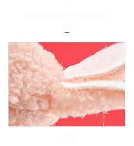 Macro shot of soft pink sherpa fleece material on a Christmas rabbit girl plush ornament