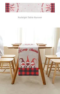 Detail of red black plaid Christmas table runner with Merry Christmas gnome motifs