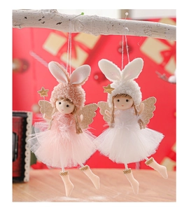 Close-up of plush angel doll ornaments with rabbit ears and sequins on a branch