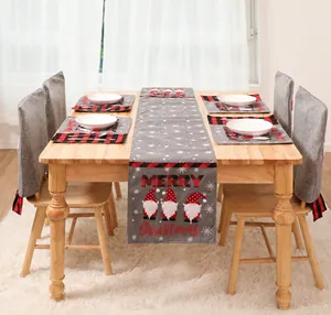 Close-up of Christmas table runner set with red buffalo plaid trim and gnome patterns