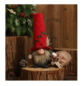 Detailed view of a Christmas gnome figurine with red spiral hat and mini burlap gift bag