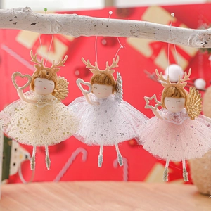 Three plush Christmas angel dolls with antlers and sequin skirts on a red festive background