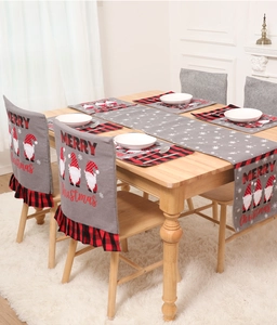 Close-up of gray Christmas chair covers and table runner with festive gnome patterns