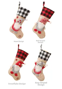 Set of four beige linen Christmas stockings with festive gnome patterns and plaid cuffs