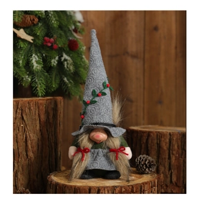Detail of Christmas female gnome doll with long brown hair and embroidered grey pointed hat