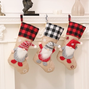 Three Christmas gnome stockings with red black buffalo plaid and rustic burlap for mantle décor