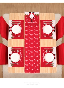 Detail of Christmas table runner and placemats set with Santa Claus and snowflake prints