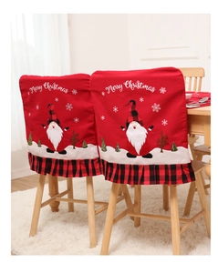 Detail of red Christmas chair covers with plaid trim and festive Santa embroidery