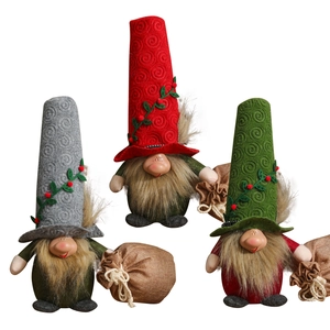 Three Christmas gnomes with spiral hats and burlap gift bags for festive home decoration