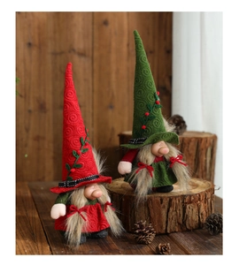 Detail of red and green Christmas gnomes featuring textured hats and long braids decorations