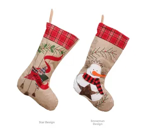 Detail of Christmas burlap stockings featuring embroidered Welcome and Joy with snowman and star