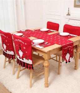 Detail of red Christmas table runner and chair covers with festive gnome snowflake patterns