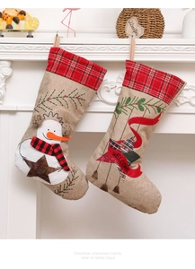 Detail of burlap Christmas stockings with embroidered snowman and JOY/WELCOME lettering