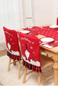 Close-up of red Christmas table runner and chair covers with snowflake and Santa patterns
