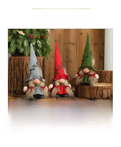 Detailed view of three festive Christmas gnomes with spiral hats and berry accents