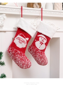 Knitted Christmas stockings with Santa and snowman hanging on a white fireplace
