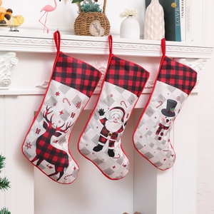 Set of three large plaid Christmas stockings with Santa, snowman and reindeer designs