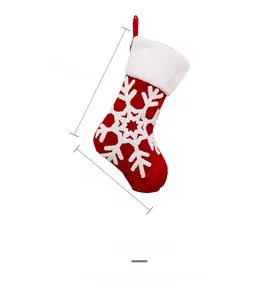 Detailed size view of red Christmas stocking with white snowflake and plush cuff