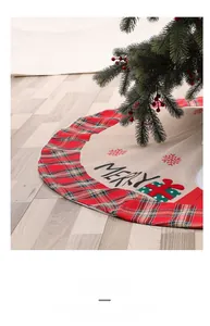 Detail of red plaid Christmas tree skirt with Merry printing on textured linen fabric