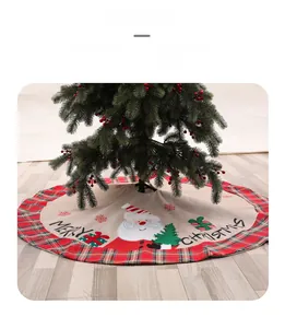 Detail of red plaid Christmas tree skirt with Santa Claus motif and Merry Christmas text