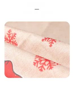 Close-up of red snowflake print and reindeer pattern on cotton linen apron fabric