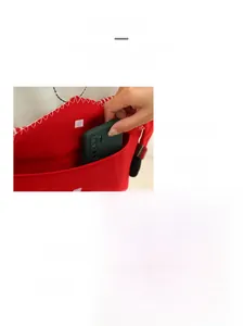 Detail of red Christmas chair cover with storage pocket and white wave stitching