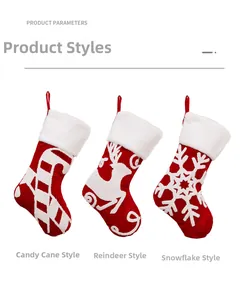 Detailed view of three red Christmas stockings with reindeer, snowflake, and cane embroidery