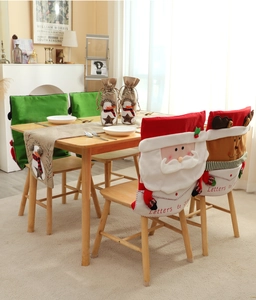 Close-up of Santa and Reindeer chair covers with burlap table runner for Christmas dining