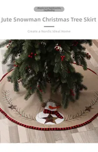 Detail of burlap Christmas tree skirt with snowman embroidery and festive red plaid trim