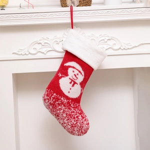 Knitted red Christmas stocking with white plush cuff and snowman pattern for decor