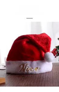 Dettaglio del ricamo dorato Nice sul bordo in peluche bianca del classico cappello di Natale