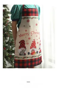 Detail of Christmas gnomes and Merry Christmas print on checkered plaid kitchen apron