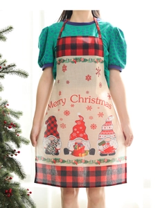 Close-up of a Christmas gnome apron with red and black plaid and Merry Christmas print