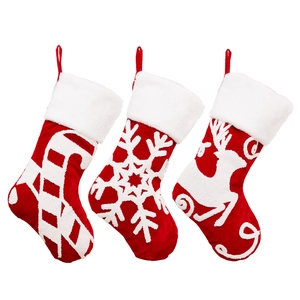 Three red velvet Christmas stockings with plush trim featuring candy cane, snowflake, and reindeer