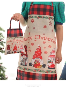 Detail of Christmas gnome kitchen apron and matching tote bag with red plaid trim