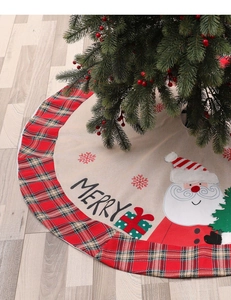 Close-up of beige linen Christmas tree skirt with Santa Claus motif and red plaid border