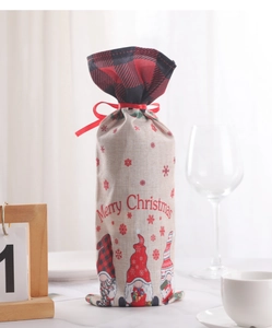 Close-up of burlap Christmas wine bag with gnomes and Merry Christmas print