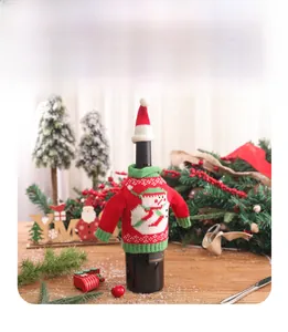 Detailed close-up of festive red knitted Christmas wine bottle cover with snowman design